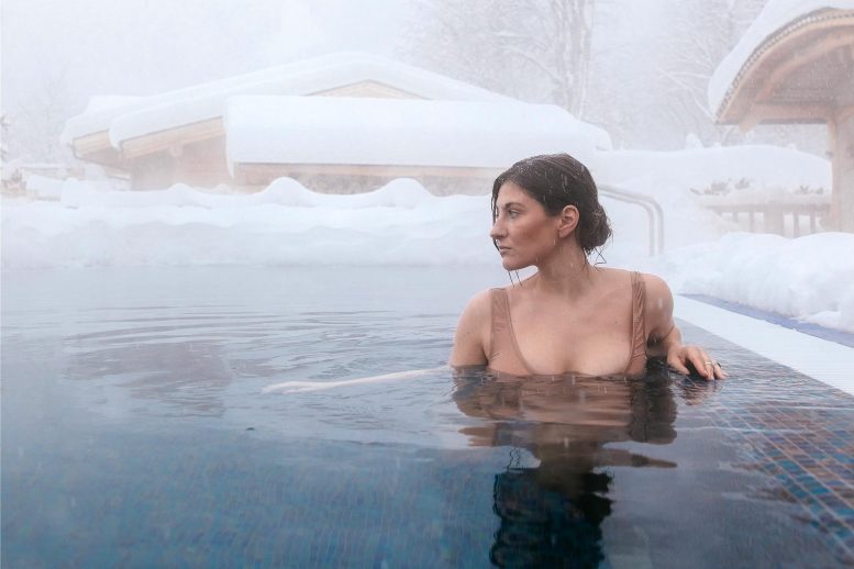 Femme en piscine d'eau froide à l'extérieur en hiver