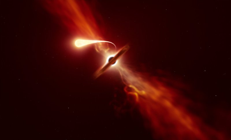 Cette illustration représente une étoile (au premier plan) subissant une spaghettification alors qu'elle est aspirée par un trou noir supermassif (en arrière-plan) lors d'un 