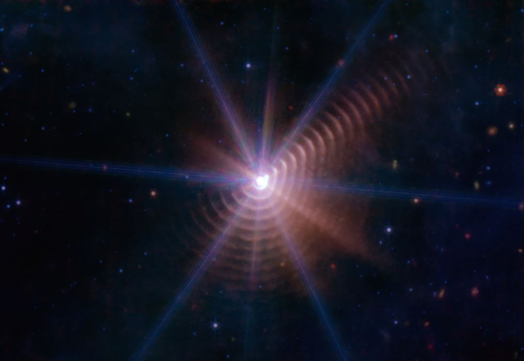 Il s'agit d'une image JWST d'une autre étoile Wolf-Rayet, WR 140, faisant partie d'une paire binaire d'étoiles. Les anneaux de cette image sont des éjections épisodiques de poussière de l'étoile. WR 140 est un exemple prototypique de production de poussière cosmique. Crédit d'image : Par NASA, ESA, CSA JWST MIRI & Ryan Lau et al. ; Traité par Meli thev - Travail personnel, CC BY-SA 4.0, https://commons.wikimedia.org/w/index.php?curid=121325992