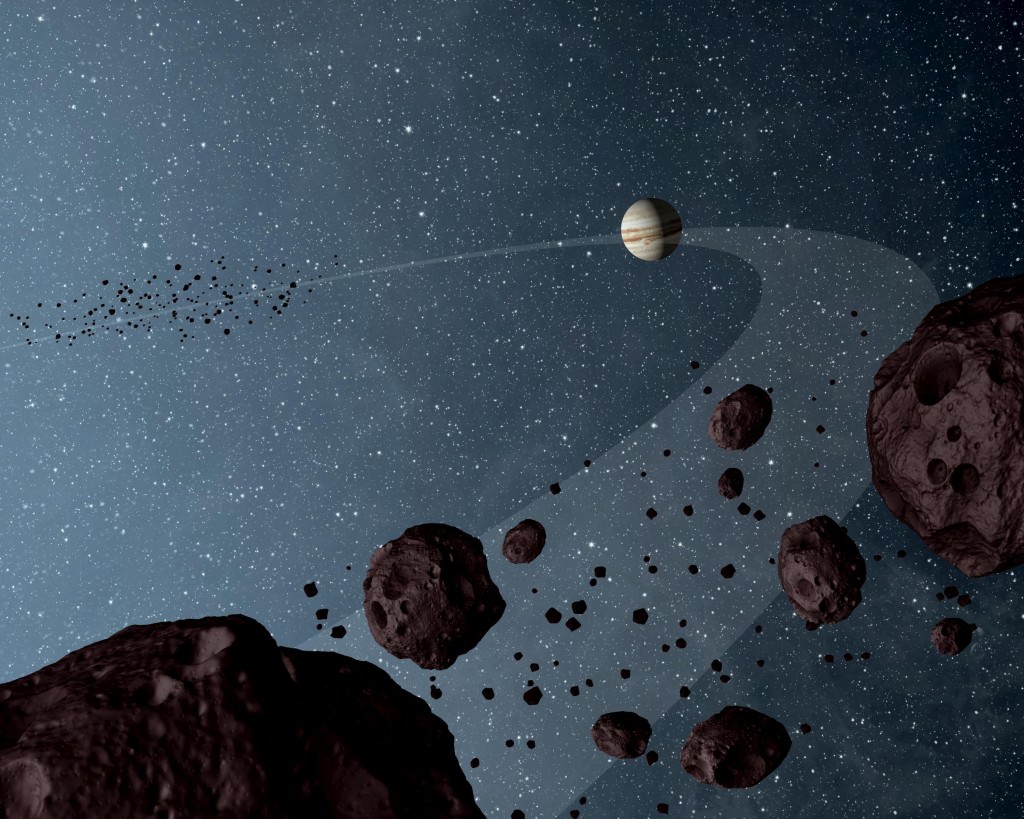 Schéma d'artiste de Jupiter et de quelques astéroïdes troyens à proximité de la géante gazeuse. Crédit : NASA/JPL-Caltech